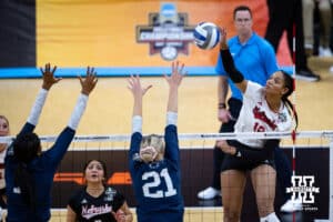 Nebraska Cornhuskers outside hitter Taylor Landfair (12) spikes the ball against the Penn State Nittany Lions during the semi-final round in the NCAA championship Thursday, December 19, 2024, in Louisville, Kentucky. Photo by John S. Peterson.