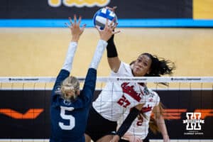 Nebraska Cornhuskers outside hitter Harper Murray (27) spikes the ball against Penn State Nittany Lions middle blocker Jordan Hopp (5) during the semi-final round in the NCAA championship Thursday, December 19, 2024, in Louisville, Kentucky. Photo by John S. Peterson.