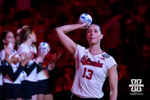 Nebraska Cornhuskers outside hitter Merritt Beason (13) throws out a mini volleyball during introductions for the semi-final round in the NCAA championship against the Penn State Nittany Lions Thursday, December 19, 2024, in Louisville, Kentucky. Photo by John S. Peterson.