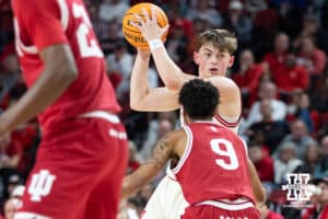 Nebraska Cornhuskers guard Connor Essegian (0) looks for the pass against Indiana Hoosiers guard Kanaan Carlyle (9) in the second half during a college basketball game Friday, December 13, 2024 in Lincoln, Nebraska. Photo by Jaelle Johnson.