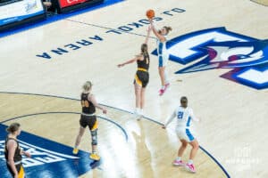 Creighton Bluejays Morgan Maly shoots a contest three pointer during a college basketball game against the Wyoming Cowgirls on December 17th, 2024 in Omaha Nebraska. Photo by Brandon Tiedemann.