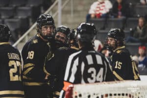 Forward, Sam Stange, caught up with players from Lindenwood during a hockey match at Baxter Arena on Saturday, December 14, 2024, in Omaha, Nebraska. Photo by Collin Stilen.