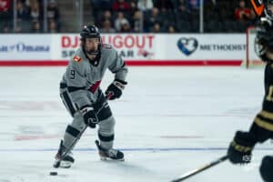 Forward, Brady Risk, looking for a pass during a hockey match at Baxter Arena on Saturday, December 14, 2024, in Omaha, Nebraska. Photo by Collin Stilen.