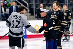 Defenseman, Nolan Krenzen, shakes hands during a hockey match at Baxter Arena on Saturday, December 14, 2024, in Omaha, Nebraska. Photo by Collin Stilen.