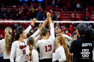 Nebraska Cornhuskers huddle up after the win over the Dayton Flyers in the fourth set during the first regional match in the NCAA championship Friday, December 13, 2024, in Lincoln, Nebraska. Photo by John S. Peterson.