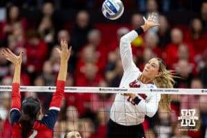Nebraska Cornhuskers middle blocker Andi Jackson (15) spikes the ball against Dayton Flyers middle hitter Liana Sarkissian (12) in the third set during the first regional match in the NCAA championship Friday, December 13, 2024, in Lincoln, Nebraska. Photo by John S. Peterson.