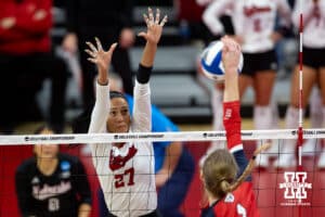 Nebraska Cornhuskers outside hitter Harper Murray (27) prepares to block against Dayton Flyers outside hitter Brooke Smith (1) in the third set during the first regional match in the NCAA championship Friday, December 13, 2024, in Lincoln, Nebraska. Photo by John S. Peterson.