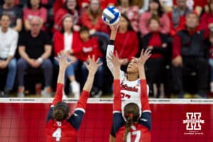Nebraska Cornhuskers outside hitter Harper Murray (27) spikes the ball against Dayton Flyers outside hitter Lexie Almodovar (4) and middle blocker Alayna Yates (17) in the third set during the first regional match in the NCAA championship Friday, December 13, 2024, in Lincoln, Nebraska. Photo by John S. Peterson.