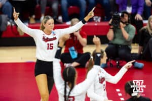 Nebraska Cornhuskers middle blocker Andi Jackson (15) celebrates a point by Bergen Reilly in the first set against the Dayton Flyers during the first regional match in the NCAA championship Friday, December 13, 2024, in Lincoln, Nebraska. Photo by John S. Peterson.