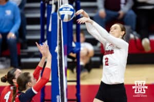 Nebraska Cornhuskers setter Bergen Reilly (2) tips the ball over against the Dayton Flyers in the first set during the first regional match in the NCAA championship Friday, December 13, 2024, in Lincoln, Nebraska. Photo by John S. Peterson.