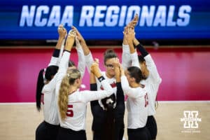 Nebraska Cornhuskers huddle up against the Dayton Flyers during the first regional match in the NCAA championship Friday, December 13, 2024, in Lincoln, Nebraska. Photo by John S. Peterson.