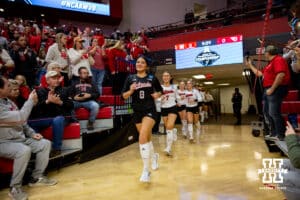 Nebraska Cornhuskers libero Lexi Rodriguez (8) leads the Huskers out against the Dayton Flyers during the first regional match in the NCAA championship Friday, December 13, 2024, in Lincoln, Nebraska. Photo by John S. Peterson.