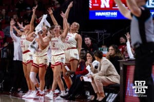 Nebraska Cornhuskers bench celebrates a three against the Minnesota Golden Gophers during a college basketball game Sunday, December 8, 2024, in Lincoln, Nebraska. Photo by John S. Peterson.