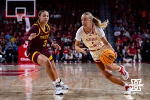 Nebraska Cornhuskers guard Alberte Rimdal (5) drives to the basket against Minnesota Golden Gophers guard Amaya Battle (3) in the first half during a college basketball game Sunday, December 8, 2024, in Lincoln, Nebraska. Photo by John S. Peterson.