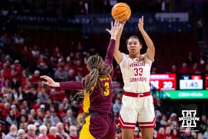 Nebraska Cornhuskers guard Amiah Hargrove (33) makes a three point shot against Minnesota Golden Gophers guard Amaya Battle (3) in the first half during a college basketball game Sunday, December 8, 2024, in Lincoln, Nebraska. Photo by John S. Peterson.