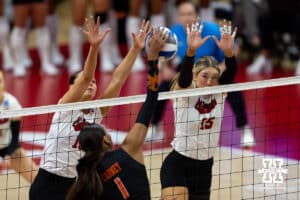Nebraska Cornhuskers outside hitter Merritt Beason (13) and middle blocker Andi Jackson (15) jump up to block Miami Hurricanes outside hitter Ava Carney (1) in the first set during the second round of the NCAA volleyball tournament Saturday, December 7, 2024, in Lincoln, Nebraska. Photo by John S. Peterson.