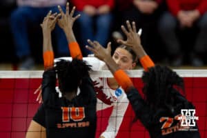Nebraska Cornhuskers outside hitter Merritt Beason (13) spikes the ball against Florida A&M Rattlers middle hitter Isis Williams (10) and middle hitter Milana Thornton (22) in the first set during the first round of the NCAA volleyball tournament Friday, December 6, 2024, in Lincoln, Nebraska. Photo by John S. Peterson.