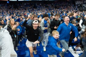 Creighton Bluejays fans storm the court after the win over the Kansas Jayhawk during a college basketball game on Wednesday, December 4th, 2024, in Omaha Nebraska. Photo by Brandon Tiedemann.