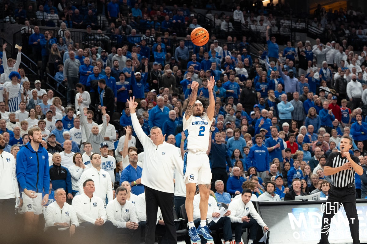 Creighton Bluejays Pop Isaac shoots a three against the Kansas Jayhawks during a college basketball game on Wednesday, December 4th, 2024 in Omaha Nebraska. Photo by Brandon Tiedemann.