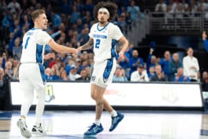 Creighton Bluejays Steven Ashworth and Pop Isaacs after a basket during a college basketball game on December 4th, 2024 in Omaha Nebraska. Photo by Brandon Tiedemann.