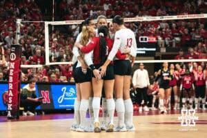 Nebraska Cornhuskers huddle up to start a set against the Indiana Hoosiers during a college volleyball game on Nov 16, 2024 in Lincoln, Nebraska. Photo by Logan Hock