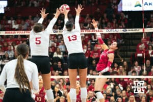 Nebraska Cornhusker middle blocker Rebekah Allick (5) and outside hitter Merritt Beason (13) jump to block against the Indiana Hoosiers during a college volleyball game on Nov 16, 2024 in Lincoln, Nebraska. Photo by Logan Hock