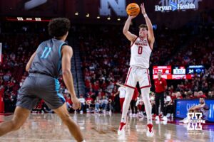 ebraska Cornhuskers guard Connor Essegian (0) makes a three-point shot against North Florida Ospreys guard Kamrin Oriol (11) in the first half during a college basketball game Sunday, December 1, 2024, in Lincoln, Nebraska. Photo by John S. Peterson.