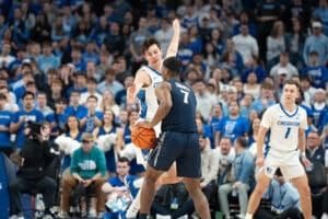 Creighton Bluejays Mason Miller closes out on a defender during a college basketball game against Xavier on January 29th, 2025 in Omaha Nebraska. Photo by Brandon Tiedemann.