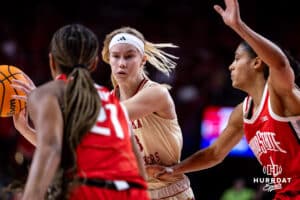 Nebraska Cornhuskers guard Britt Prince (23) makes a pass against Ohio State Buckeyes guard Chance Gray (21) and Taylor Thierry in the fourth quarter during a college basketball game, Sunday, January 26, 2025, in Lincoln, Nebraska. Photo by John S. Peterson.