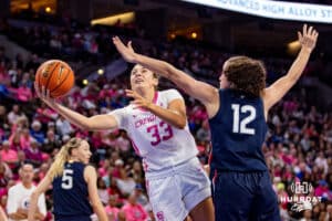Creighton Bluejays guard Brooke Littrell (33) makes a layup against UConn Huskies guard Ashlynn Shade (12) in the second half during a college basketball game, Saturday, January 25, 2025, in Omaha, Nebraska. Photo by John S. Peterson.