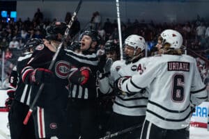 Omaha Maverick Sam Stange and St. Cloud player talking it out during a hockey match at Baxter Arena on Saturday, January 25, 2025, in Omaha, Nebraska. Photo by Collin Stilen.