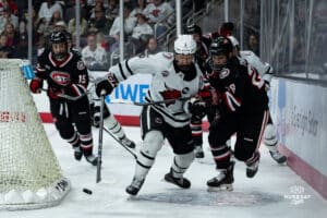 Omaha Maverick Joe Gramer battles for the puck during a hockey match at Baxter Arena on Saturday, January 25, 2025, in Omaha, Nebraska. Photo by Collin Stilen.