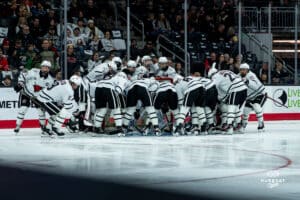 Omaha Mavericks huddle up before it starts during a hockey match at Baxter Arena on Saturday, January 25, 2025, in Omaha, Nebraska. Photo by Collin Stilen.