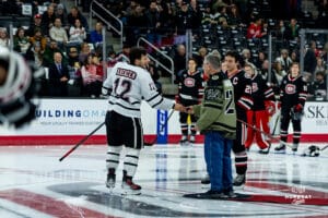 Omaha Maverick Captain Nolan Krenzen with the ceremonial pick drop during a hockey match at Baxter Arena on Saturday, January 25, 2025, in Omaha, Nebraska. Photo by Collin Stilen.