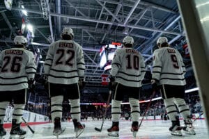 Omaha Mavericks Brock Bremer, Jimmy Glynn, Jacob Guevin and Brady Risk in the lined up for pregame activities during a hockey match at Baxter Arena on Saturday, January 25, 2025, in Omaha, Nebraska. Photo by Collin Stilen.