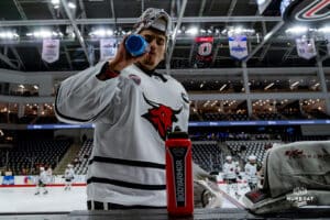 Omaha Maverick Goalkeeper Kevin Reidler grabs some water to hydrate before the game during a hockey match at Baxter Arena on Saturday, January 25, 2025, in Omaha, Nebraska. Photo by Collin Stilen.