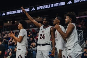 Omaha Mavericks celebrate on the sideline towards the end of the game during a basketball game at Baxter Arena on January 23rd, 2025 in Omaha Nebraska. Photo by Collin Stilen.