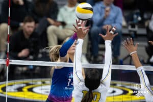 Omaha Supernovas Ally Batenhorst (14) tips the ball over San Diego Mojo Jenaisya Moore (10) during a professional volleyball match, Sunday, January 19, 2025, in Omaha, Nebraska. Photo by John S. Peterson.
