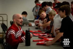 Nebraska's Brock Hardy talking with fans and signing autographs after the match against Penn State, Friday, January 17, 2025, in Lincoln, Nebraska. Photo by John S. Peterson.