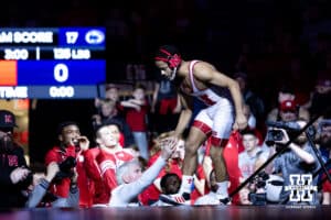 Nebraska's Caleb Smit gives coach Mark Manning five before taking on Penn State's Luke Lilledahl at 125lbs during a college wrestling match, Friday, January 17, 2025, in Lincoln, Nebraska. Photo by John S. Peterson.