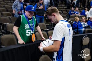 Creighton Bluejays guard Steven Ashworth (1) signs an autography for a young fan after the win over Providence Friars during a college basketball game, Tuesday, January 14, 2025, in Omaha, Nebraska. Photo by John S. Peterson.