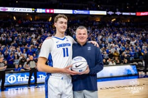Creighton Bluejays center Ryan Kalkbrenner (11) is presented a basketball to commemorate 2000 career points by Greg McDermott before taking on Providence Friars during a college basketball game, Tuesday, January 14, 2025, in Omaha, Nebraska. Photo by John S. Peterson.