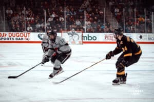 UNO Mavericks player, Nolan Krenzen, handles the puck during a college hockey game on Jan 11th, 2025 in Omaha, Nebraska. Photo by Logan Hock