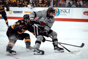 UNO Mavericks player, Zach Urdahl, clashes with an opponent during a college hockey game on Jan 11th, 2025 in Omaha, Nebraska. Photo by Logan Hock