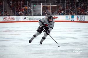UNO Mavericks player, Zach Urdahl, handles the puck during a college hockey game on Jan 11th, 2025 in Omaha, Nebraska. Photo by Logan Hock