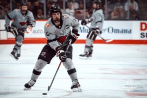 UNO Mavericks player, Jacob Guevin, looks for an open man during a college hockey game on Jan 11th, 2025 in Omaha, Nebraska. Photo by Logan Hock