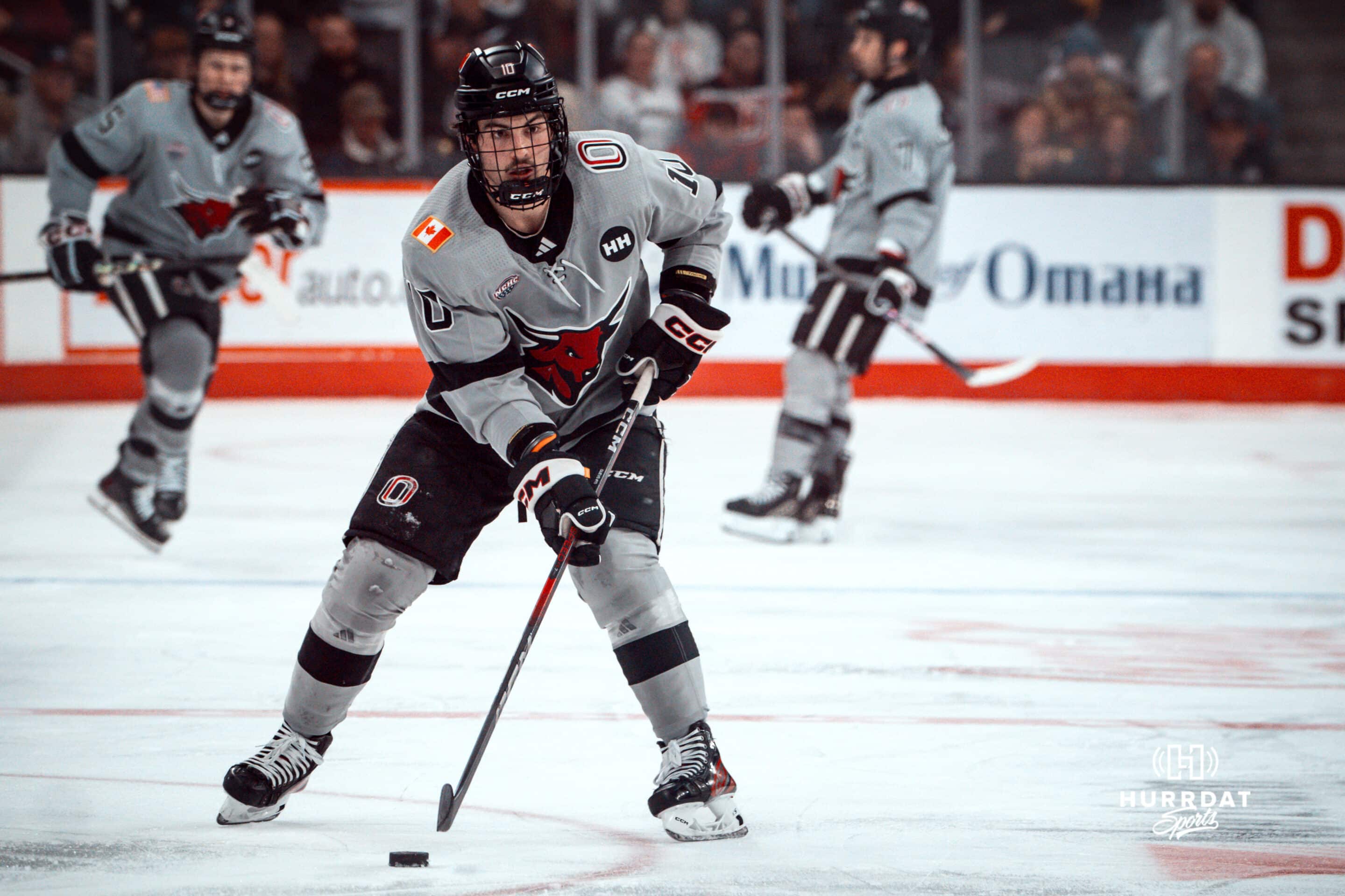 UNO Mavericks player, Jacob Guevin, looks for an open man during a college hockey game on Jan 11th, 2025 in Omaha, Nebraska. Photo by Logan Hock