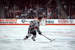 UNO Mavericks player, Dylan Gratton, handles the puck during a college hockey game on Jan 11th, 2025 in Omaha, Nebraska. Photo by Logan Hock