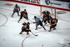 UNO Mavericks players race for the puck during a college hockey game on Jan 11th, 2025 in Omaha, Nebraska. Photo by Logan Hock