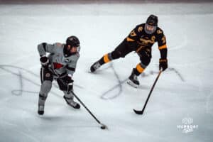 UNO Mavericks player, Griffin Ludtke, makes his way past an opponent during a college hockey game on Jan 11th, 2025 in Omaha, Nebraska. Photo by Logan Hock